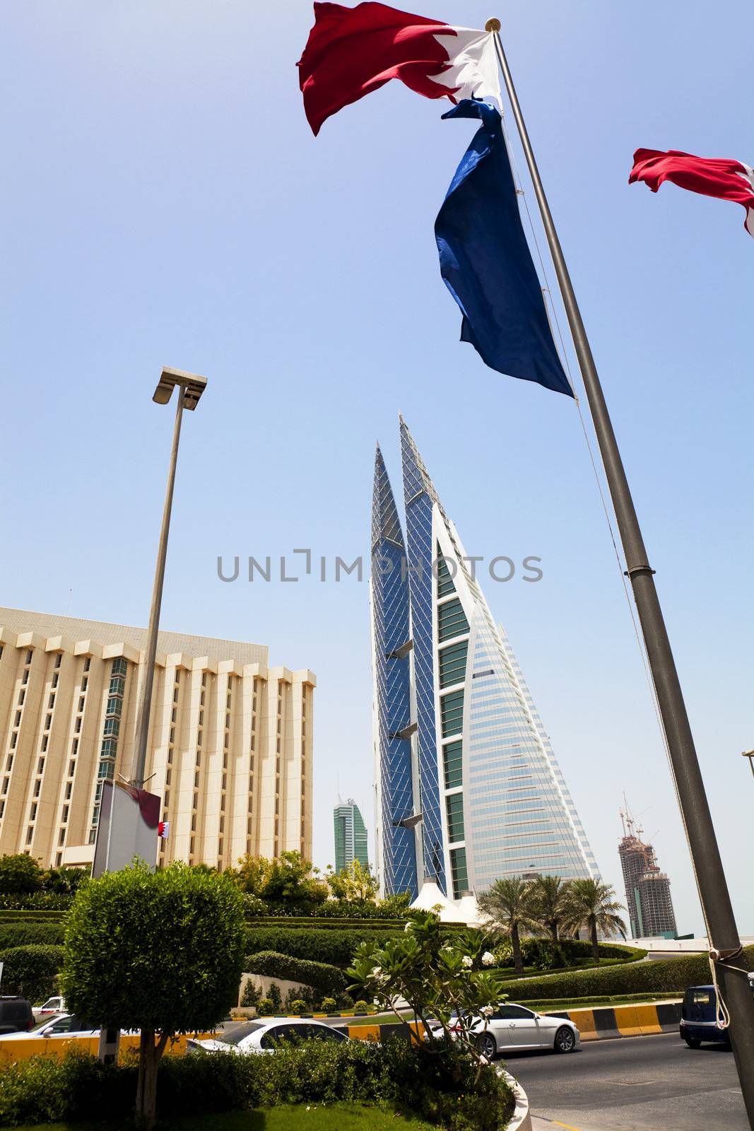 Image of Bahrain's iconic building, the Bahrain World Trade Center and Bahrain flags at Manama, Bahrain.