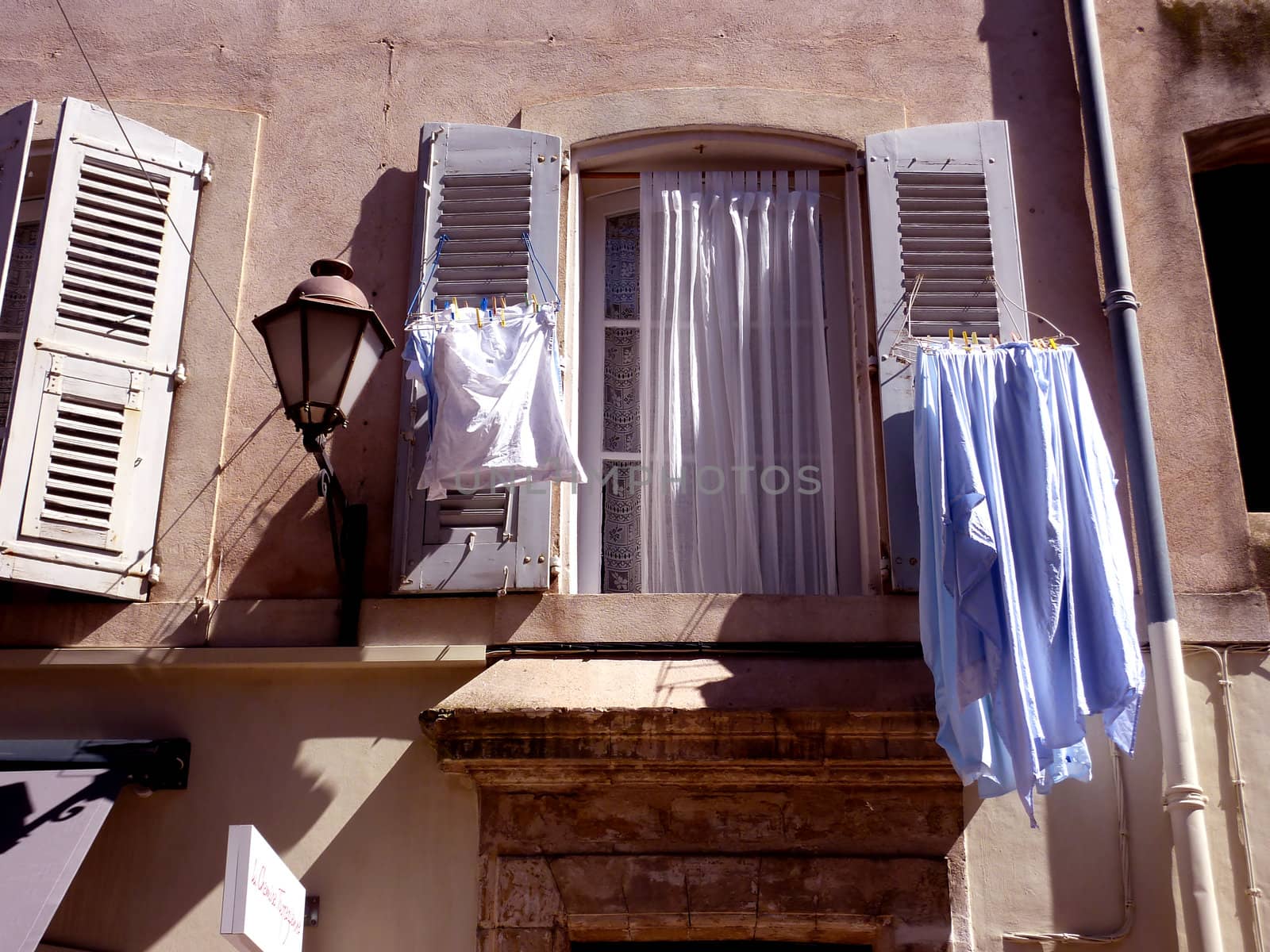 Washing drying at a window at Menton, south of France, by beautiful weather
