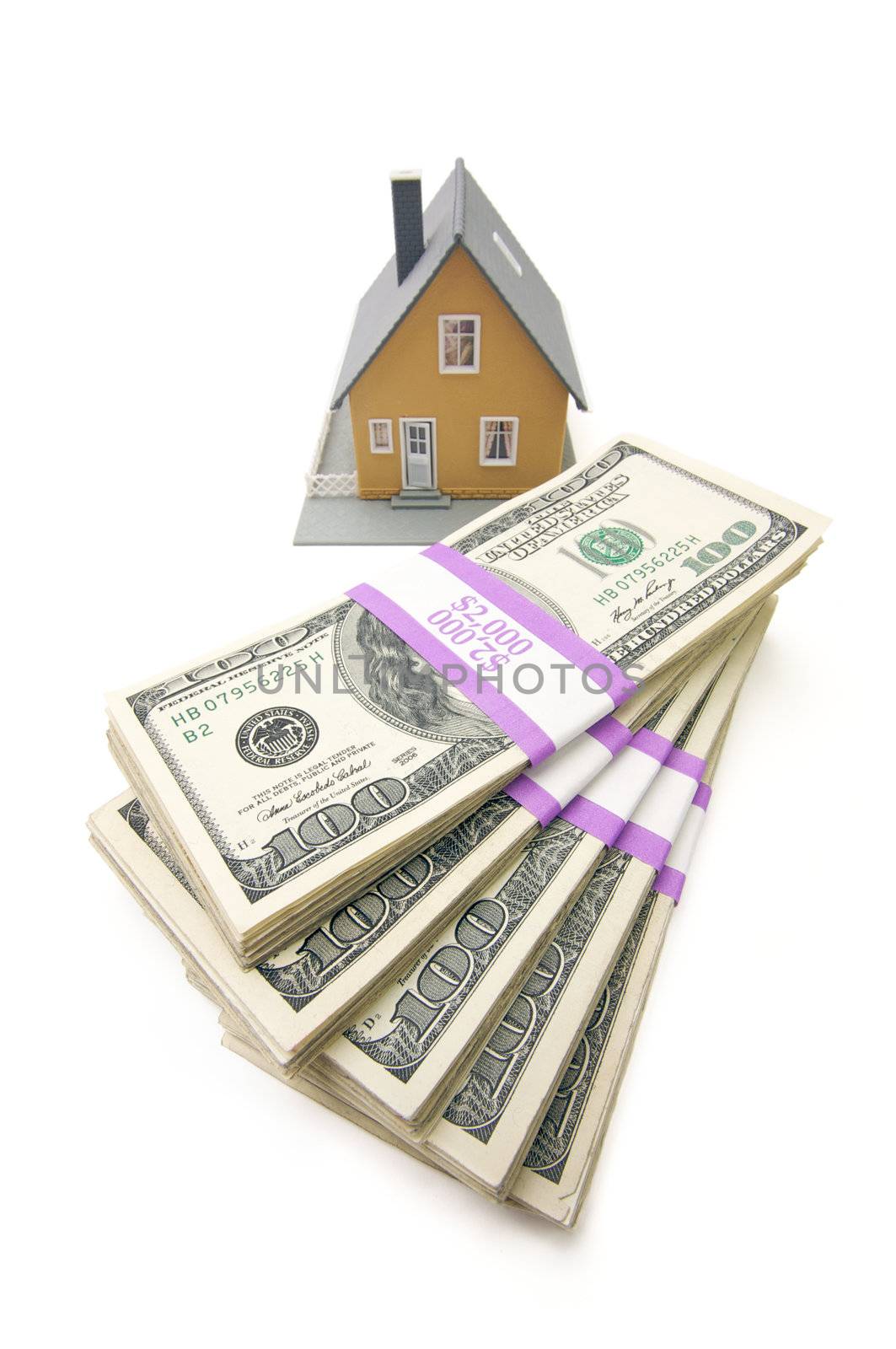 Home and Stacks of Money Isolated on a White Background