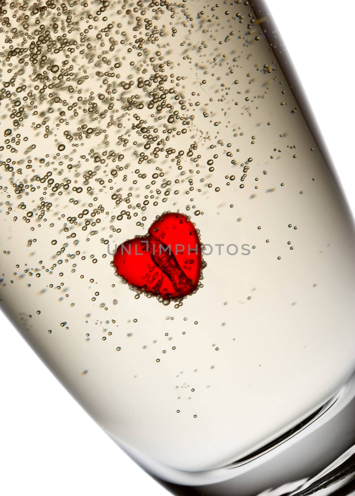 Heart in champagne flute. Isolated on white.
