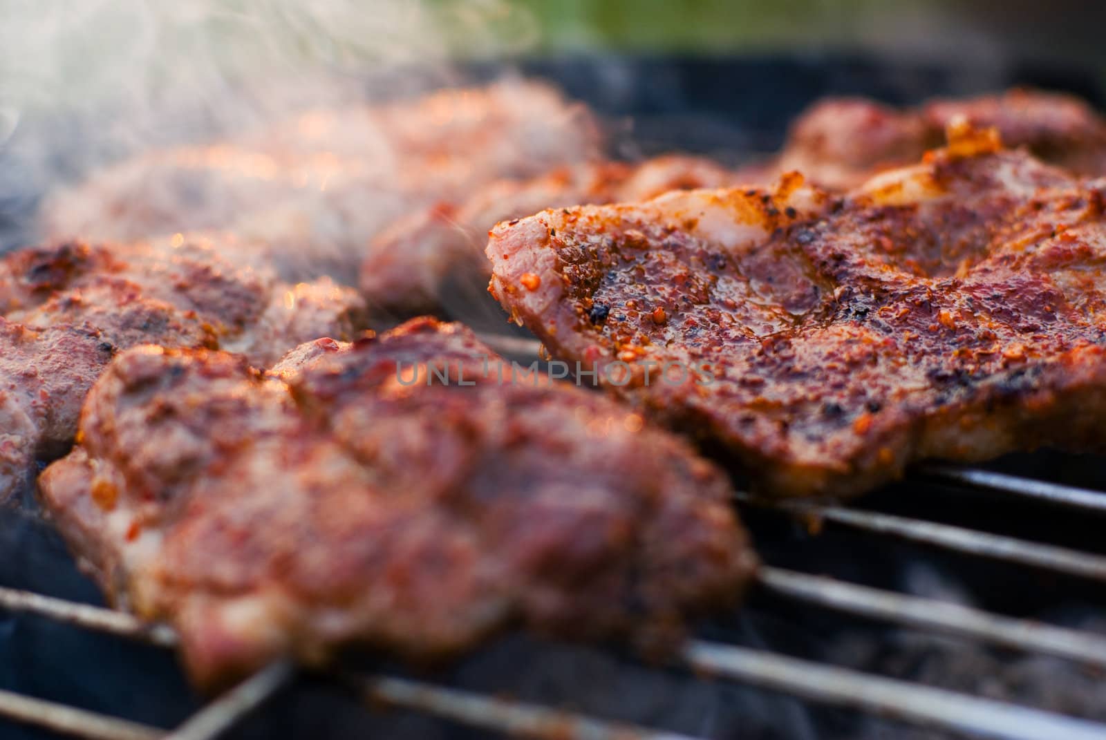 Delicious chuck steaks on the grill. Shallow depth of field.