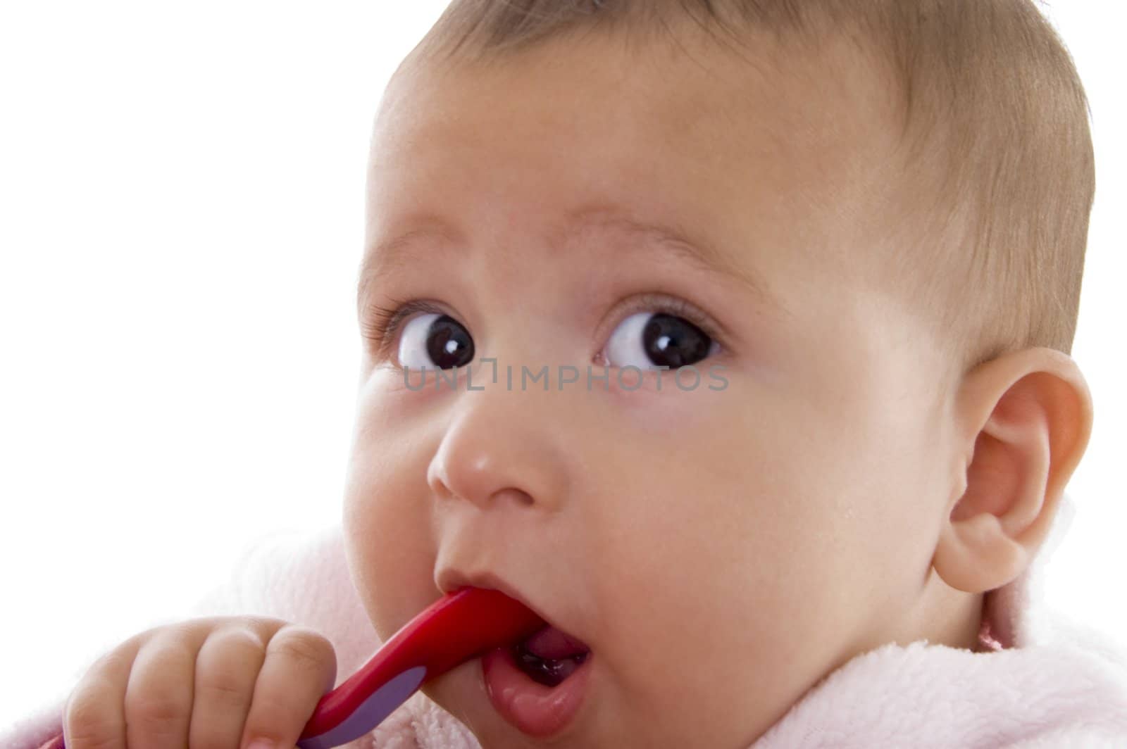 close up of cute little baby looking aside with white background