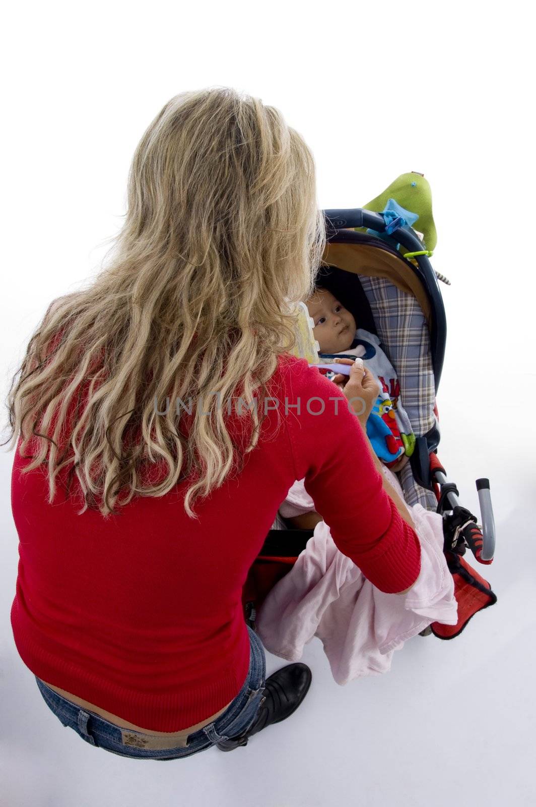 back pose of young mother with her baby in pram on an isolated background