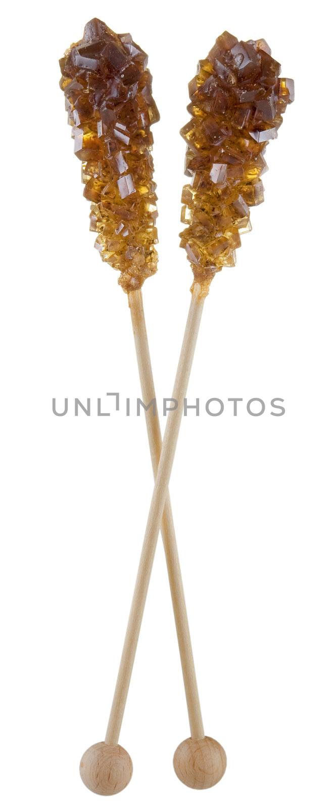 Wooden sticks with crystal cane-sugar on end on the white background