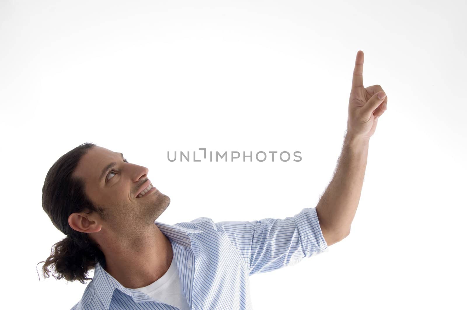 cool young guy pointing upwards against white background