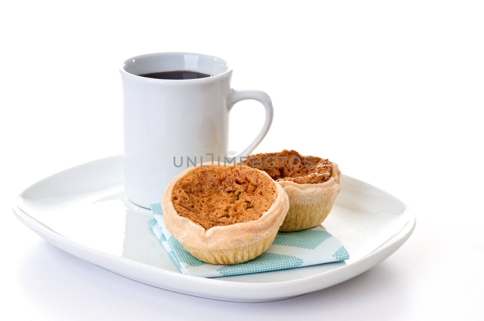 Homemade butter tarts served with fresh coffee.