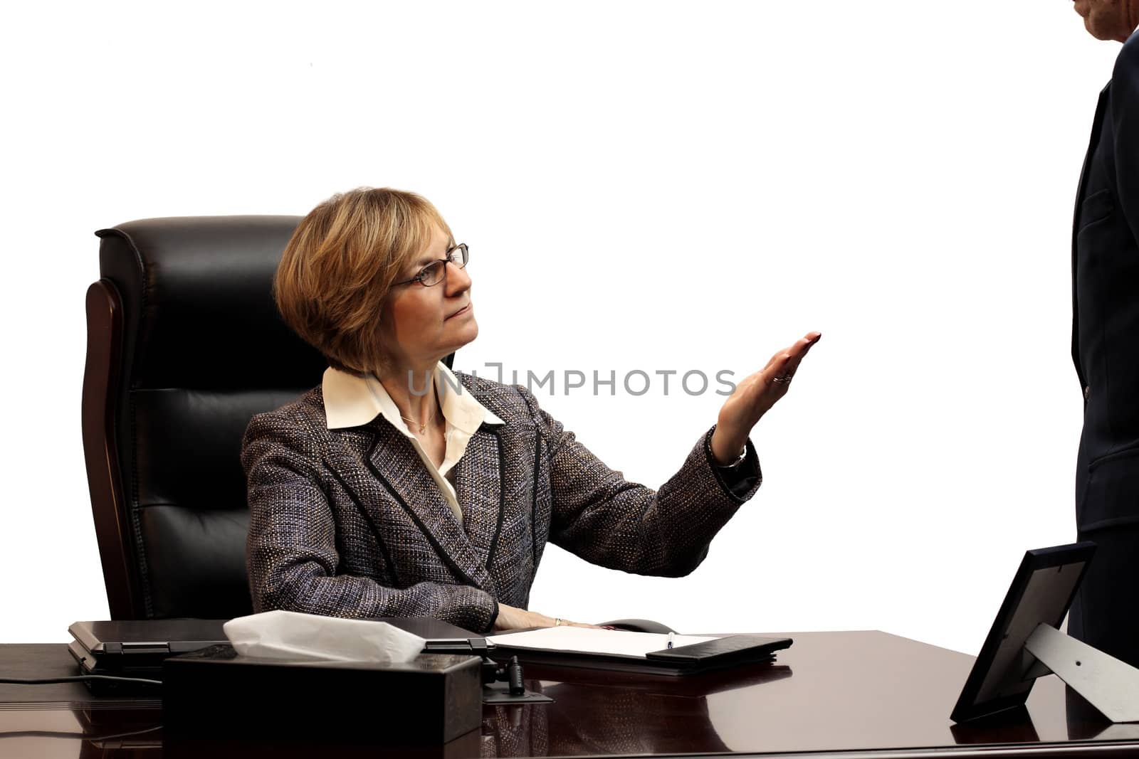 Woman executive showing leadership in explaining to male employee what must be done