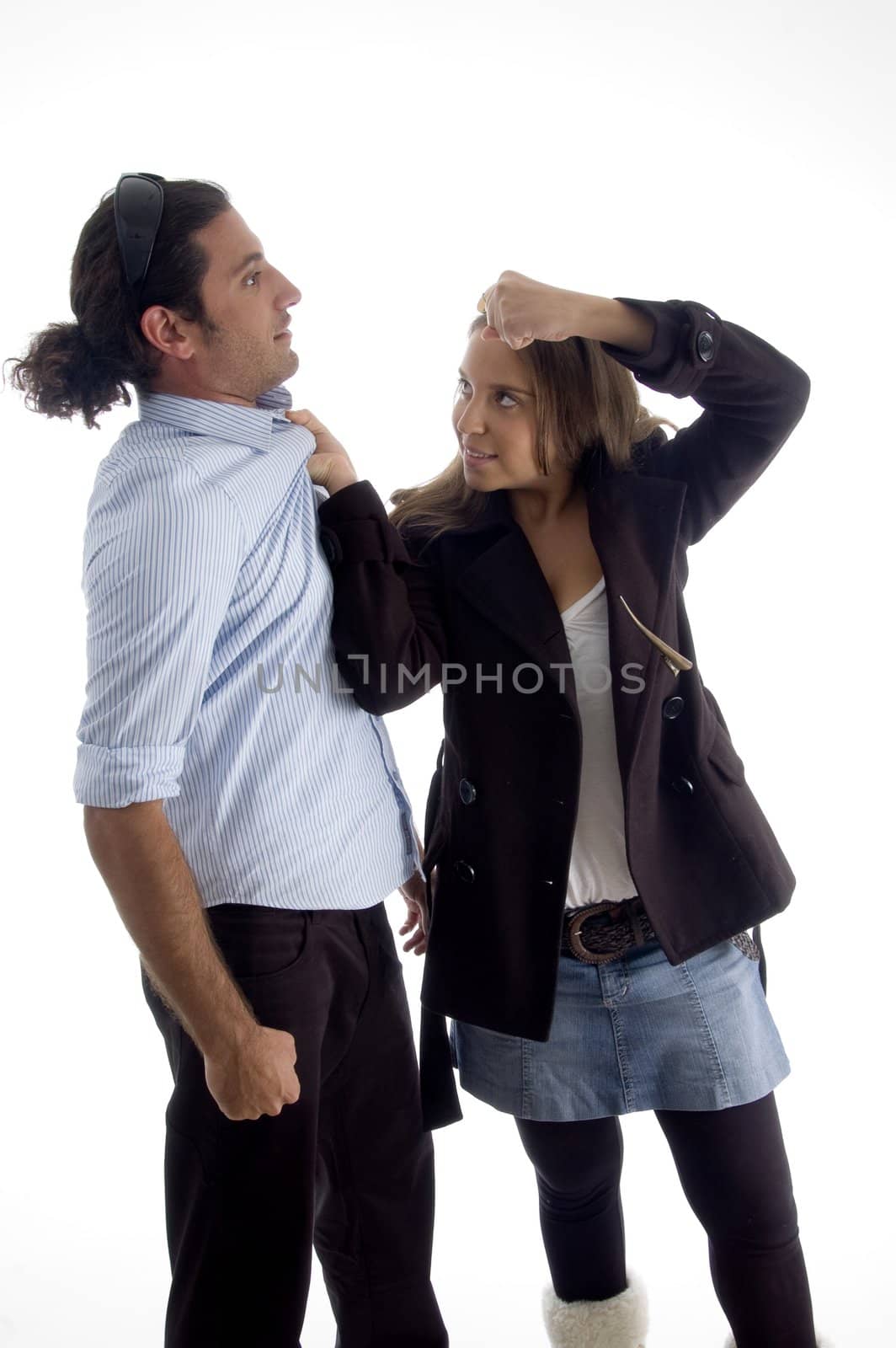 young good looking woman dominating her boyfriend with white background