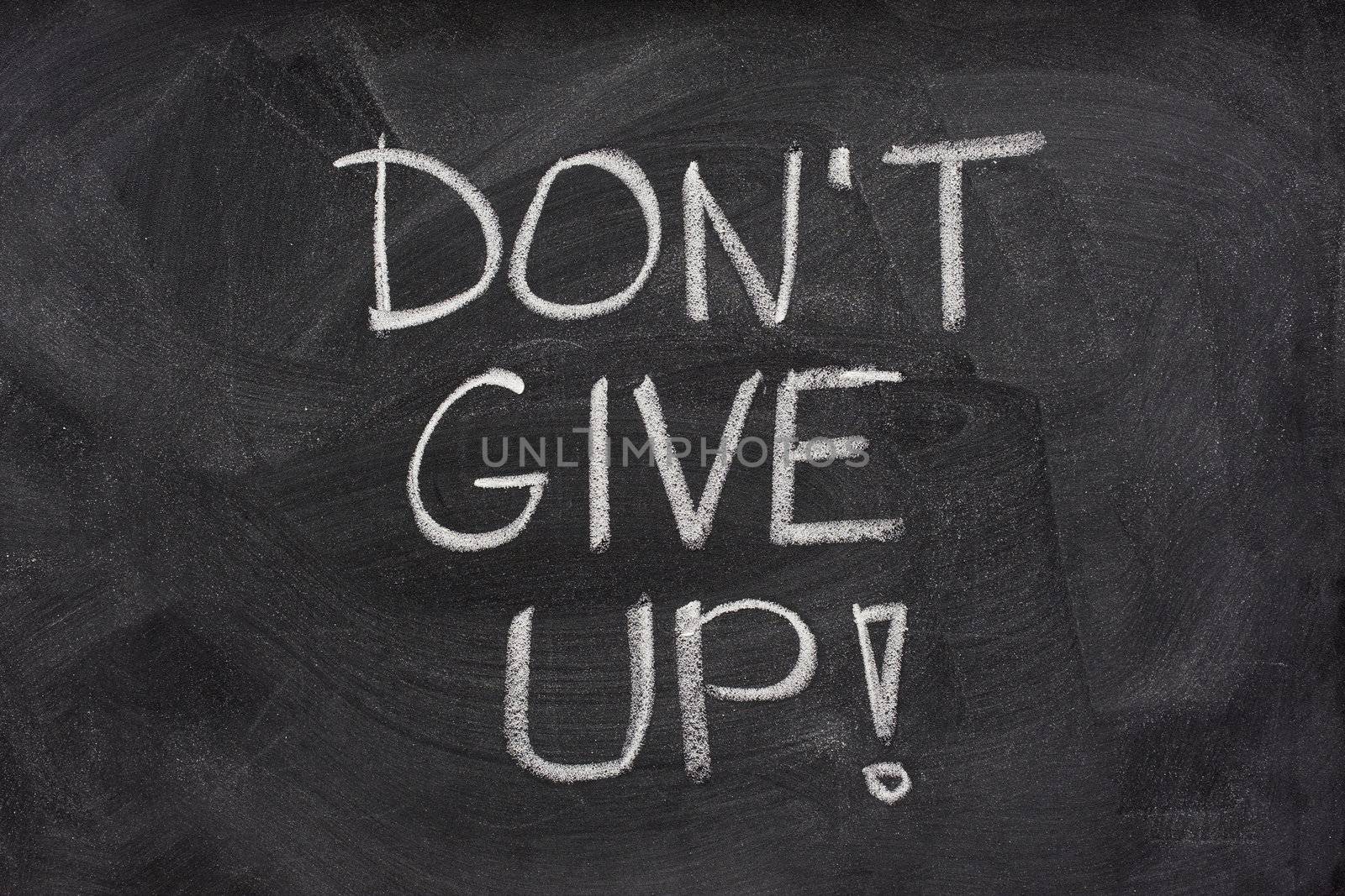 don't give up phrase on blackboard by PixelsAway