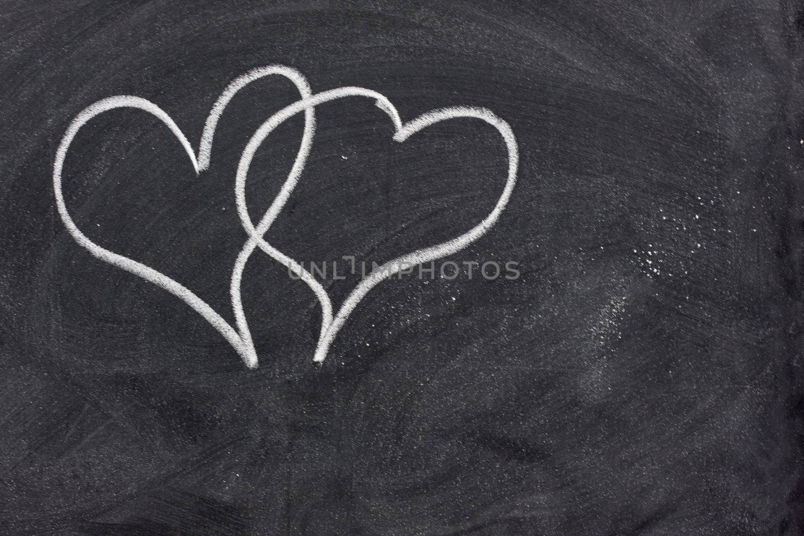 two hearts on blackboard by PixelsAway