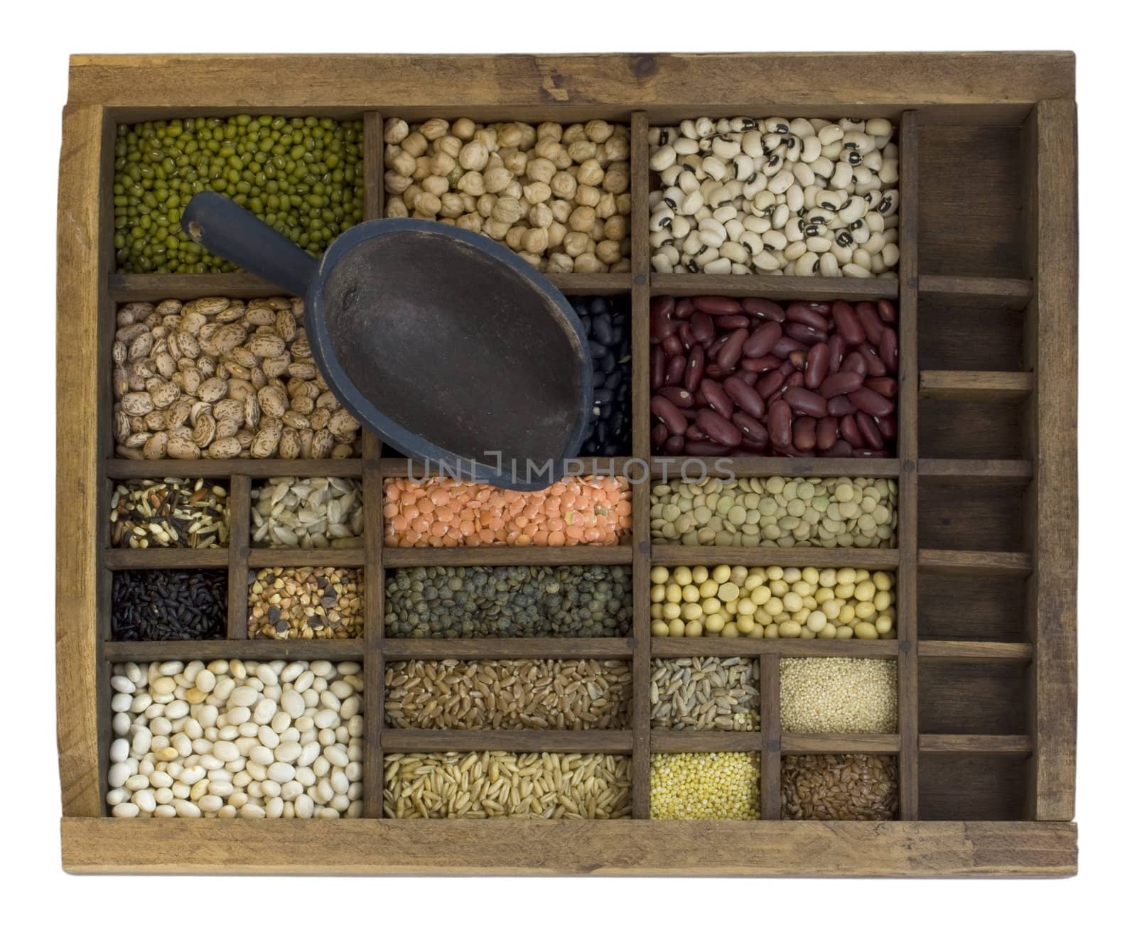 vintage scoop and old, wooden typesetter case with assorted beans, lentils, grains and seeds isolated with clipping path