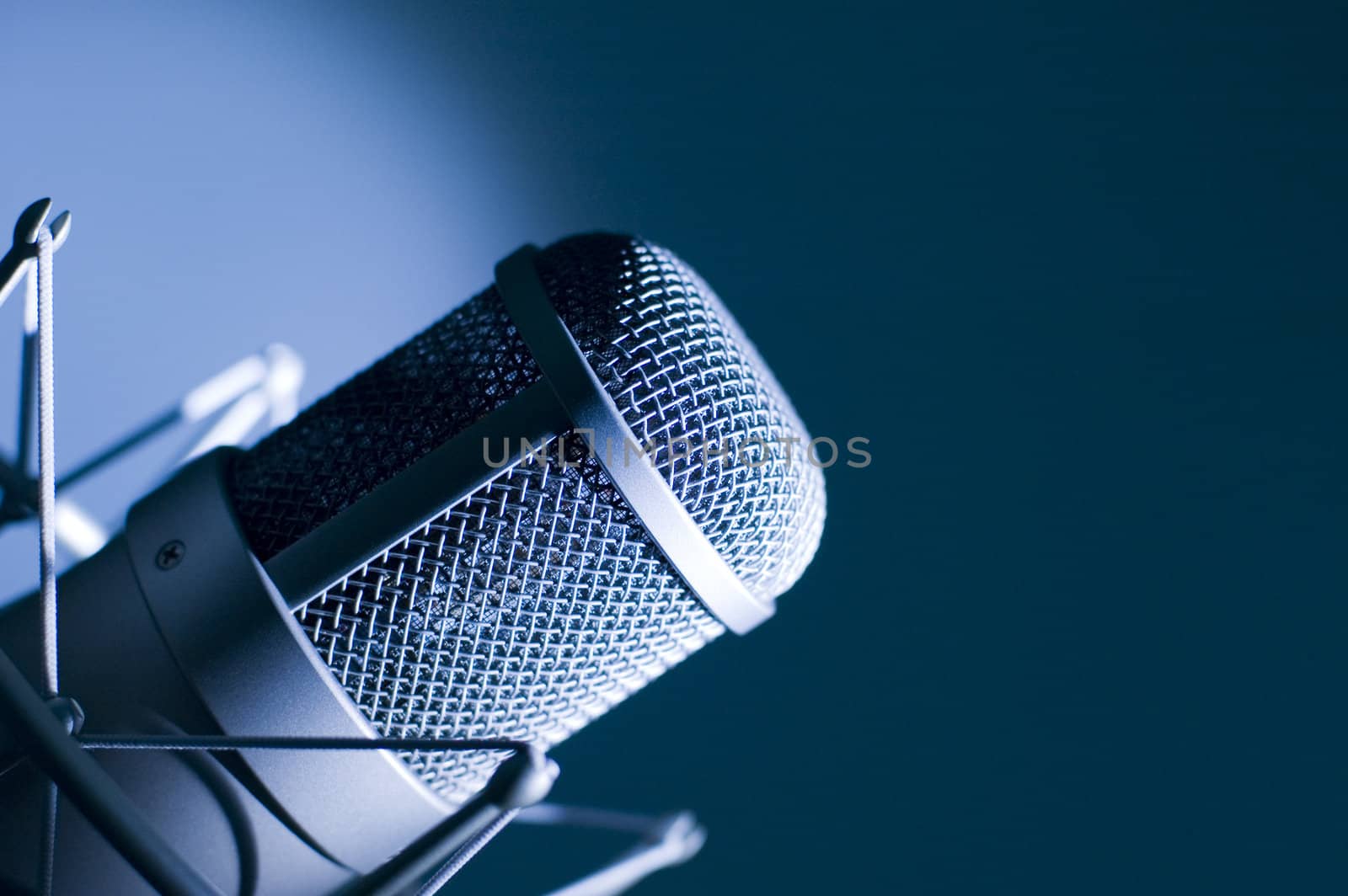 Microphone in studio. Dark blue light.