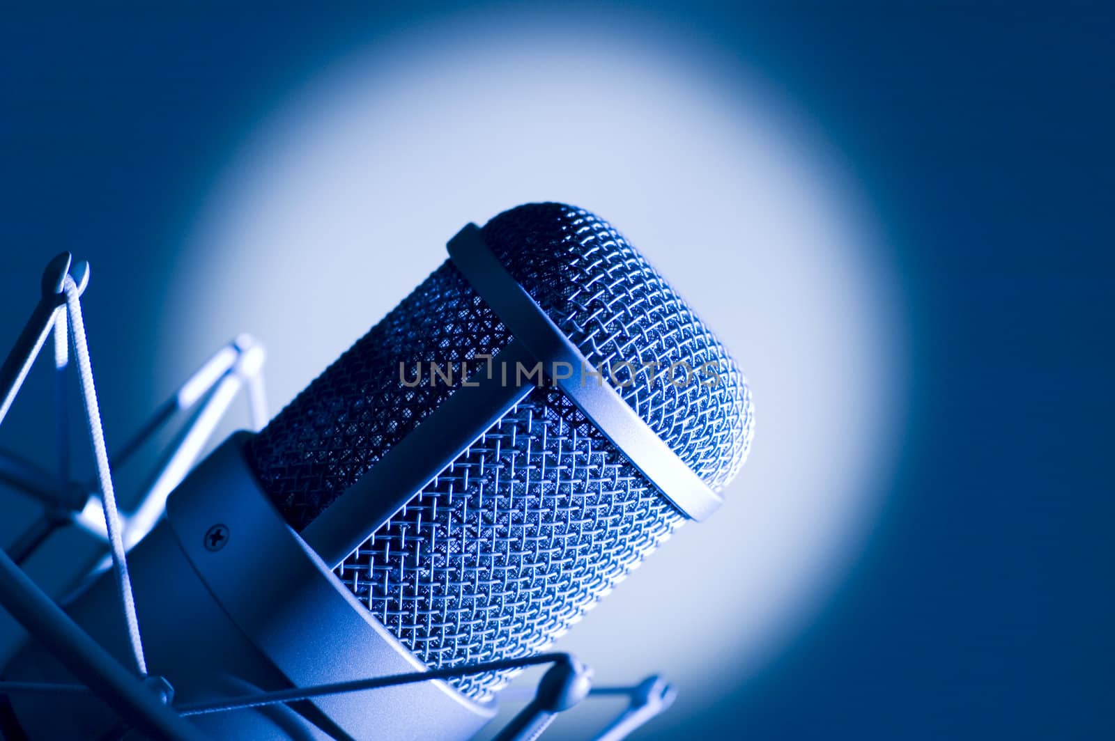 Microphone in studio. Dark blue light.