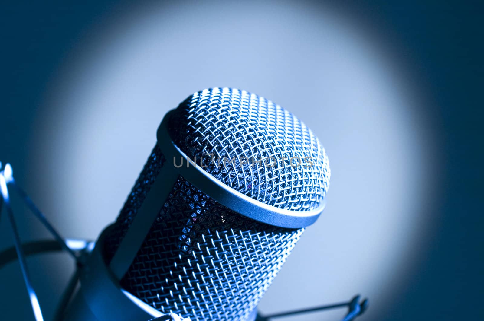 Microphone in studio. Dark blue light.