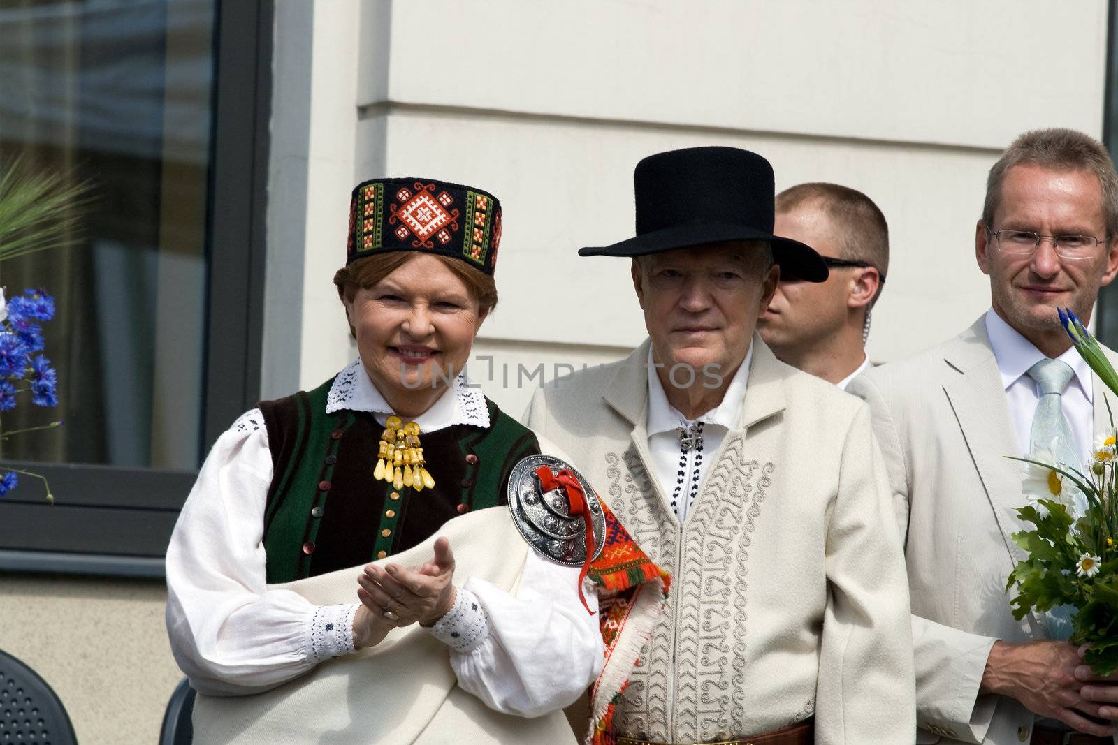 Ex-President of the Republic of Latvia Vaira Vike-Freiberga and her husband wearing traditional costume greets the participants of the procession of the Song and Dance Celebration festival in Riga, Latvia, July 6, 2008