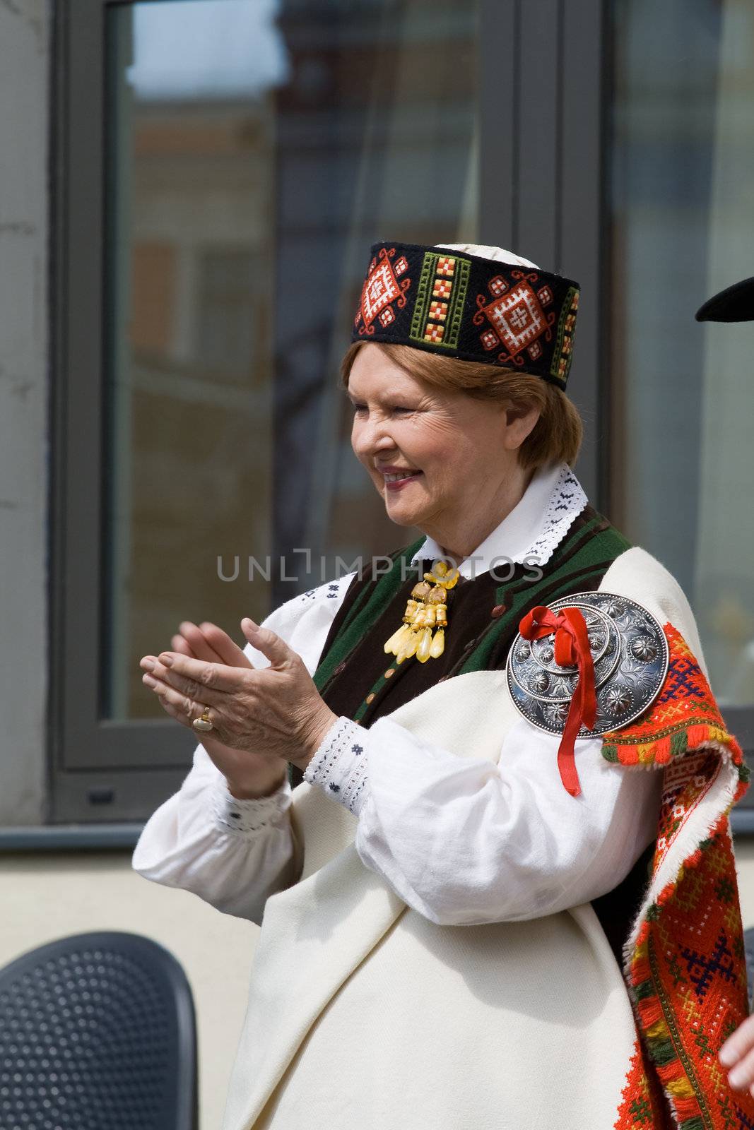 Ex-President of the Republic of Latvia Vaira Vike-Freiberga wearing traditional costume greets the participants of the procession of the Song and Dance Celebration festival in Riga, Latvia, July 6, 2008