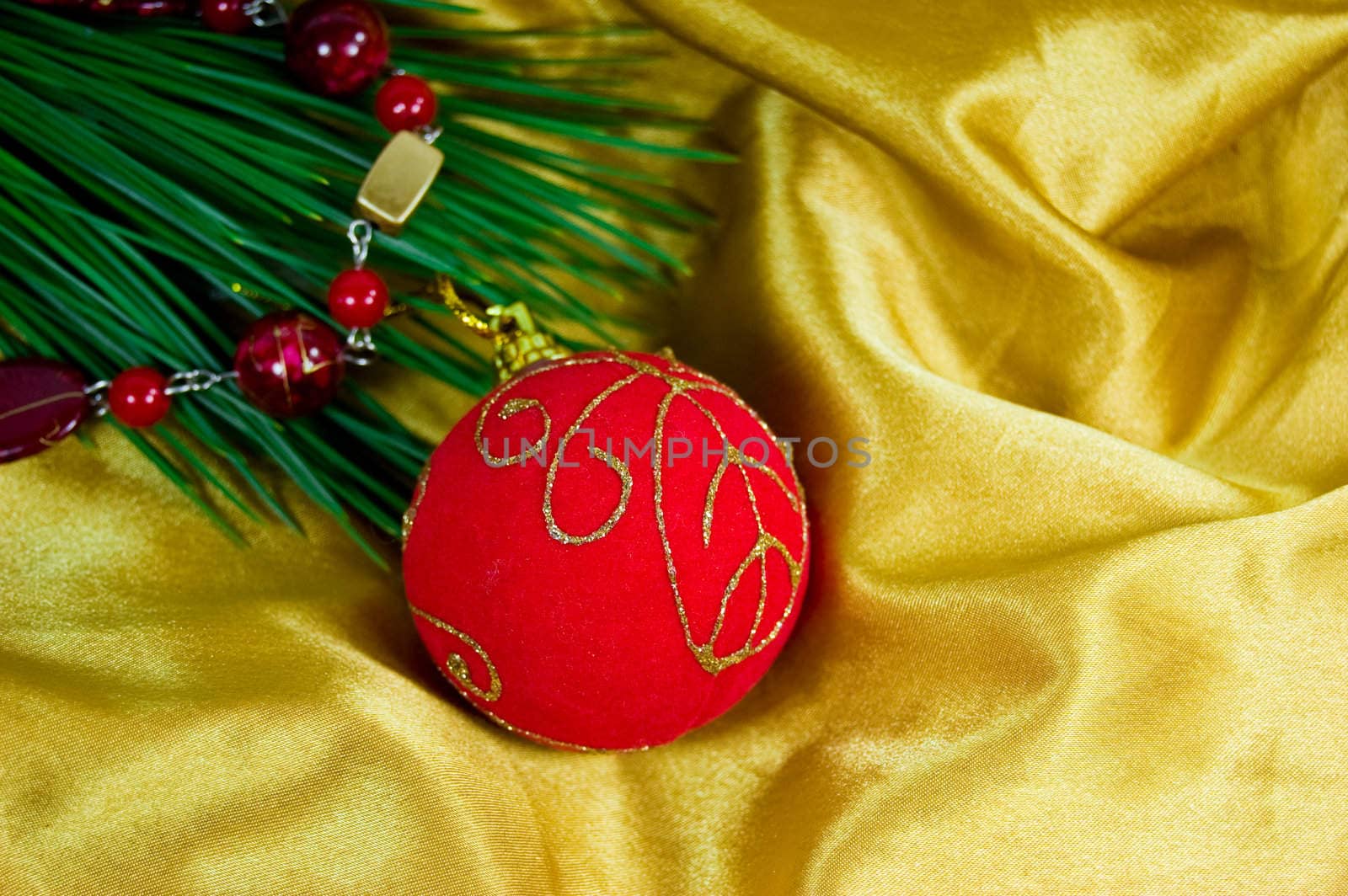 Christmas ornaments of red ball in silky golden fabric with Christmas tree