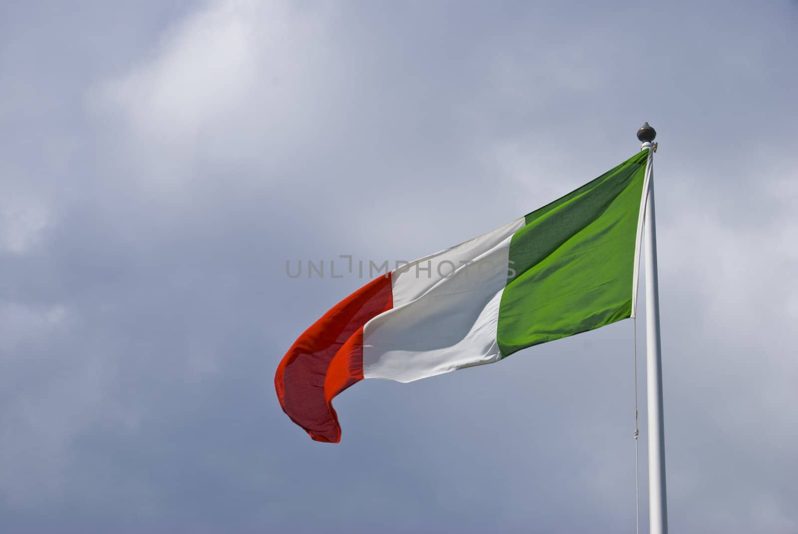 italian flag blowing in the wind on a cloudy day