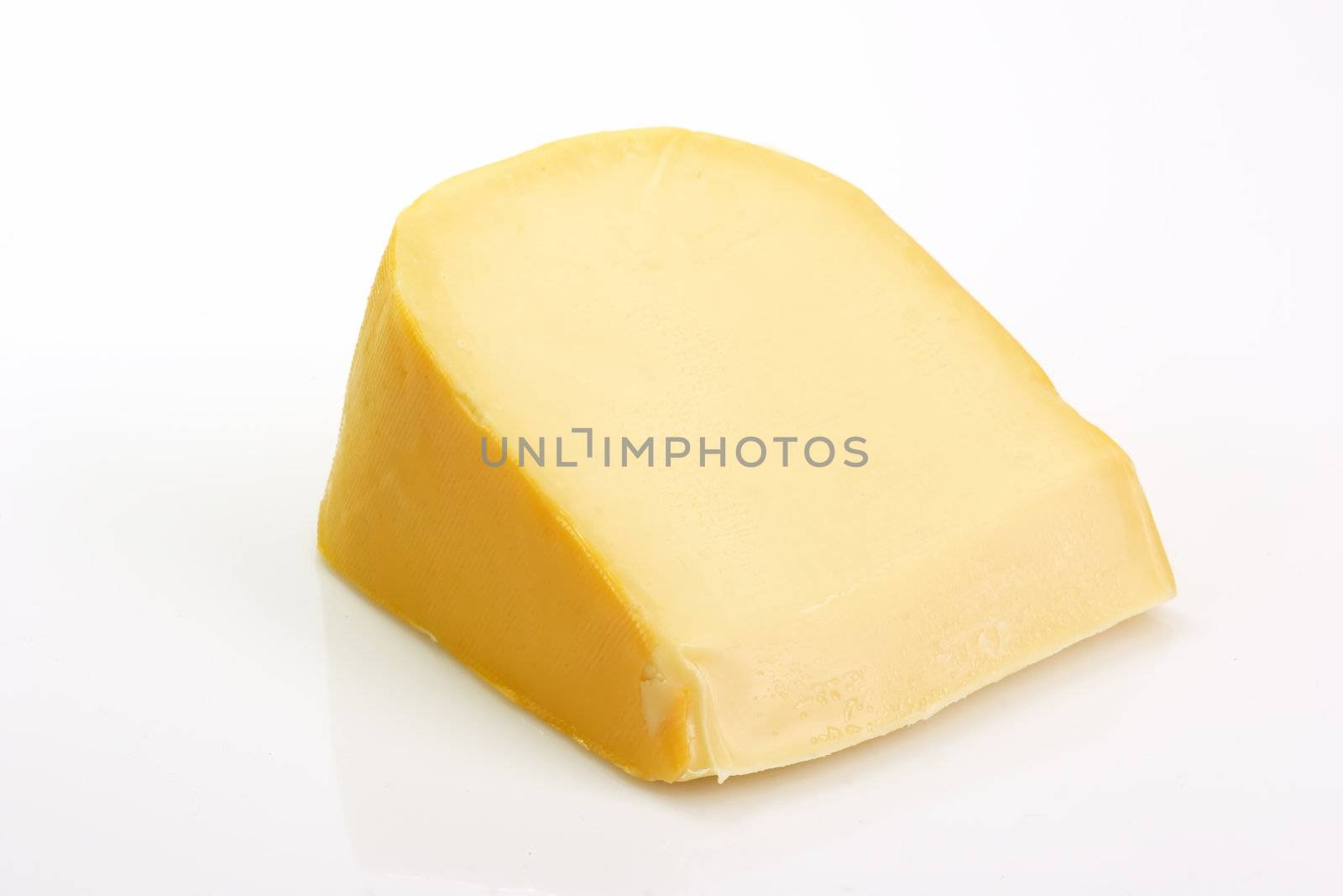 A big chunk of gouda cheese on bright background
