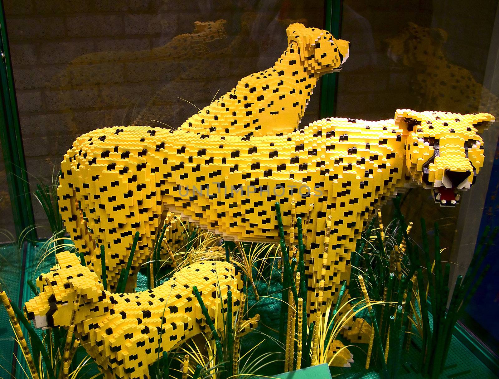Three yellow cheetahs made of lego