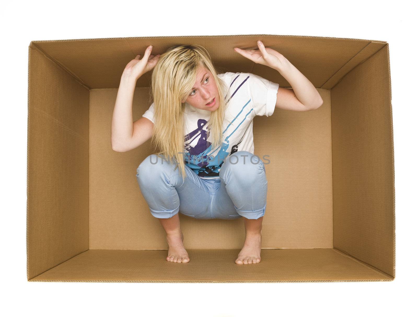 Young woman inside a Cardboard Box isolated on white