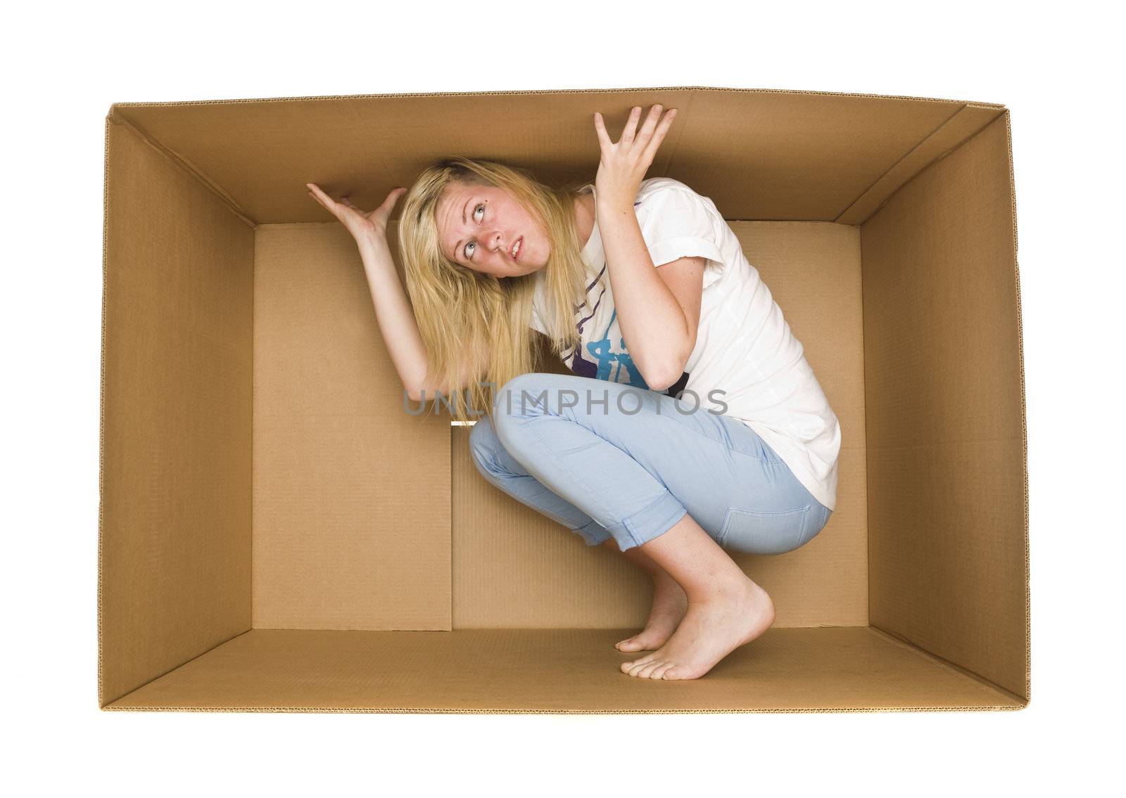 Young Woman inside a Cardboard Box isolated on white Background