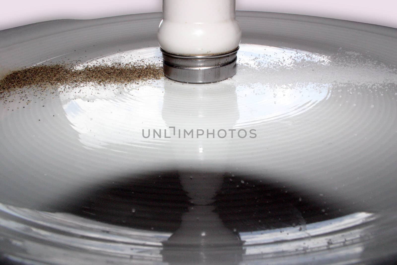 Salt and Pepper trails on white dish by ommo