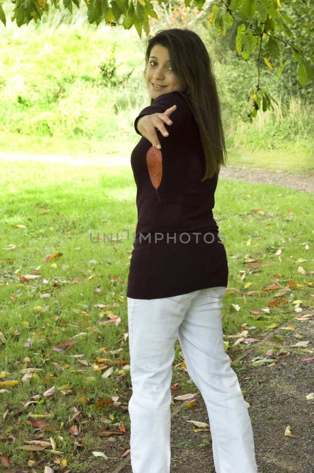 Pretty woman holding a red leaf