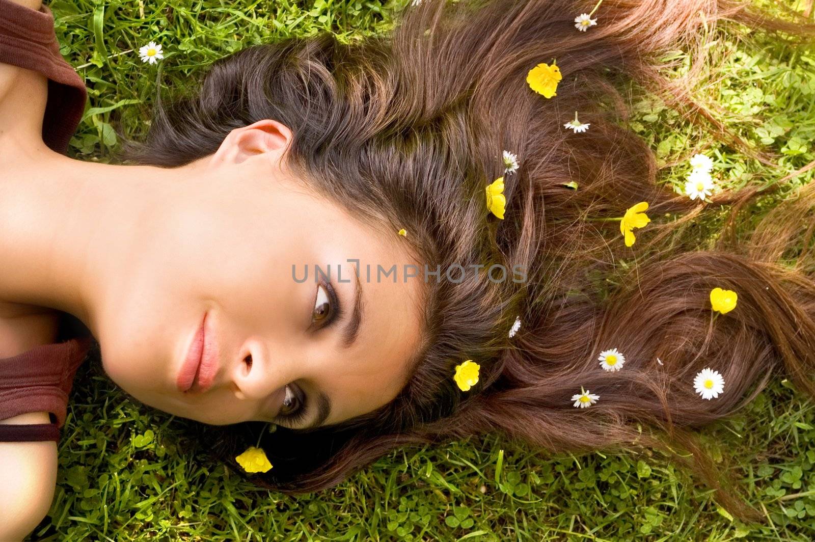 Attractive Woman with Flowers in her hair lying down. 