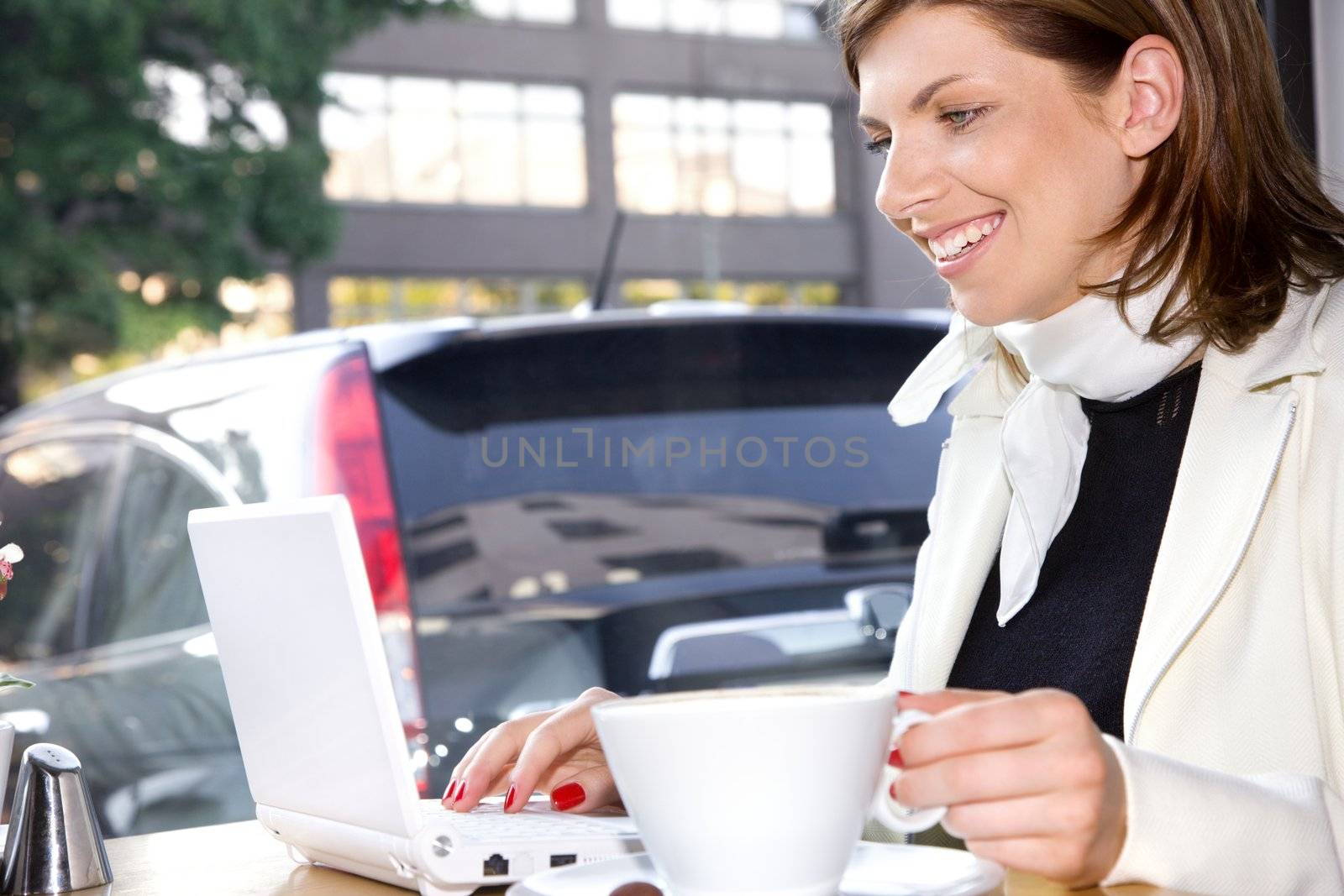 happy businesswoman drinking morning coffee and surfing internet