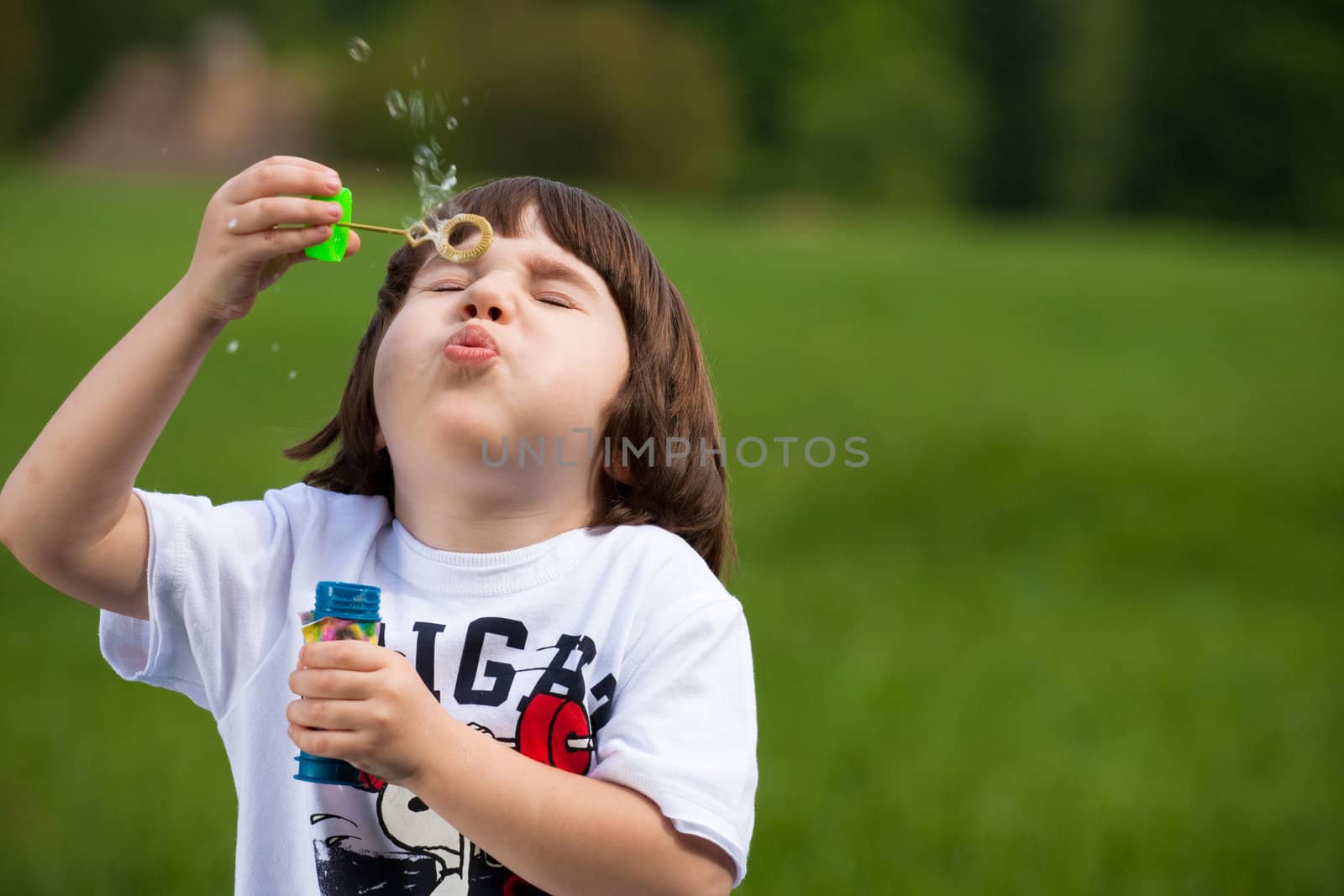 Boy tries to make a soap bubble