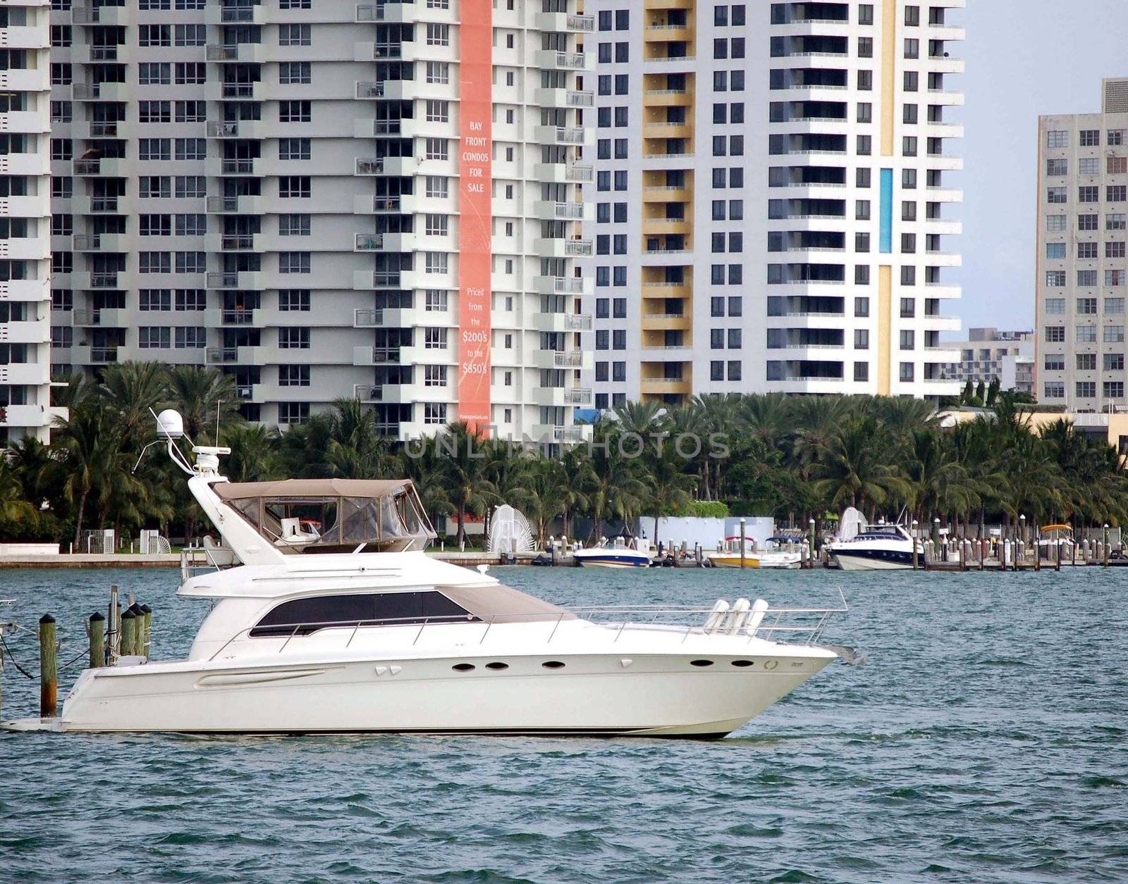 cabin cruiser moored at a Miami Beach condo marina on the florida intercoastal waterway