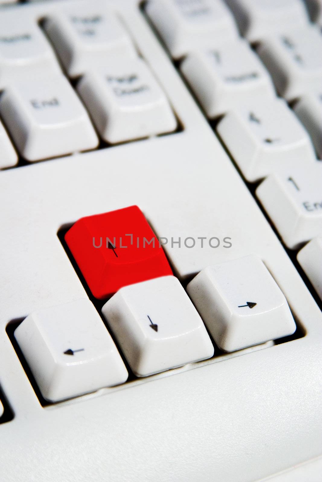 Arrow keys on a desktop computer keyboard with the up arrow red