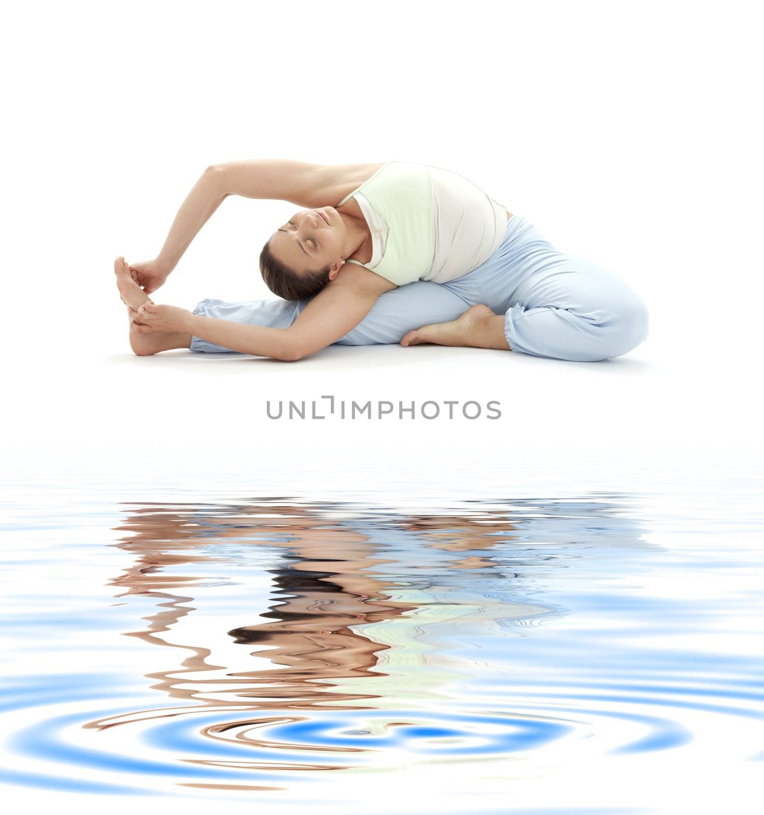 lovely girl practicing ashtanga yoga on white sand