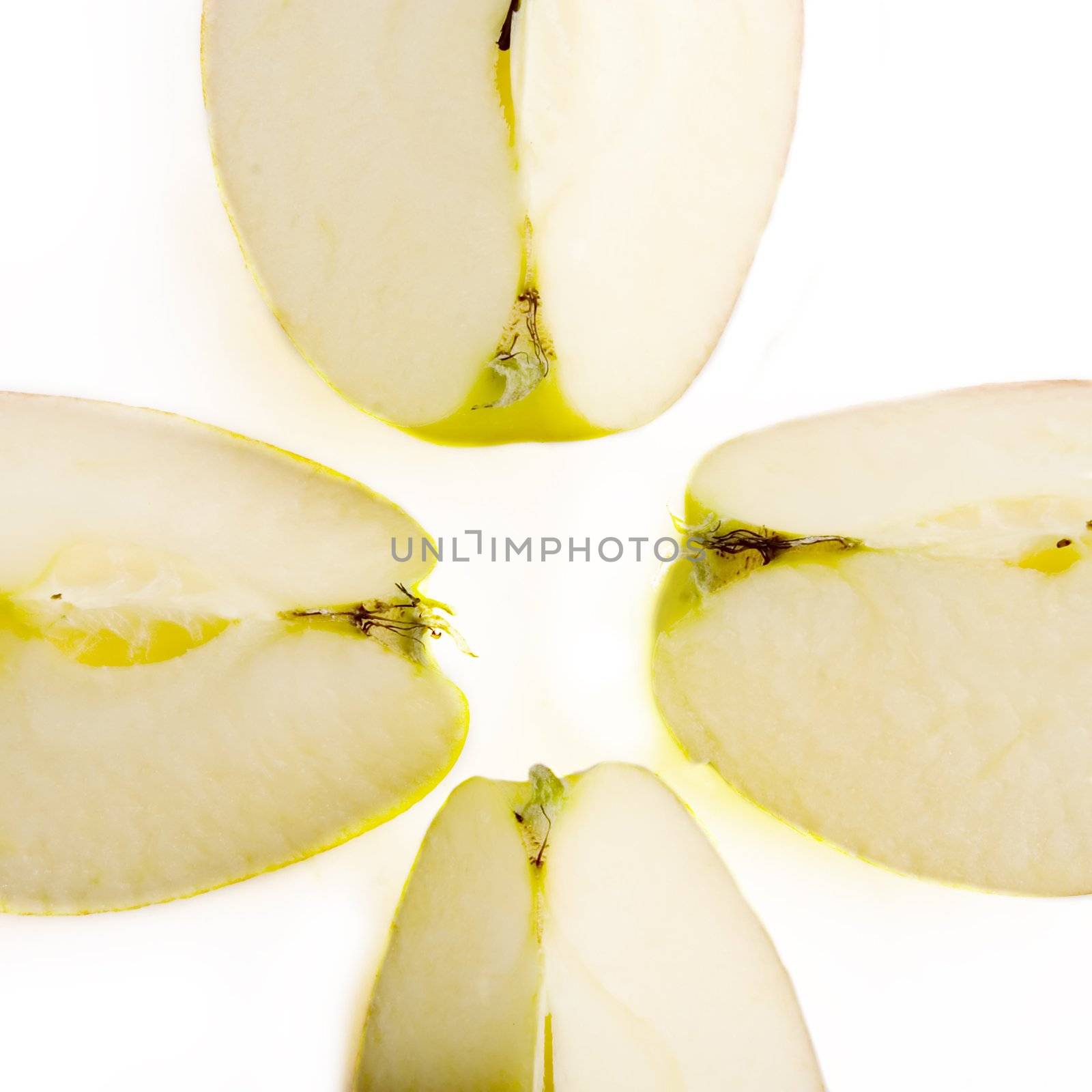 An apple slice in four quarters on a white background