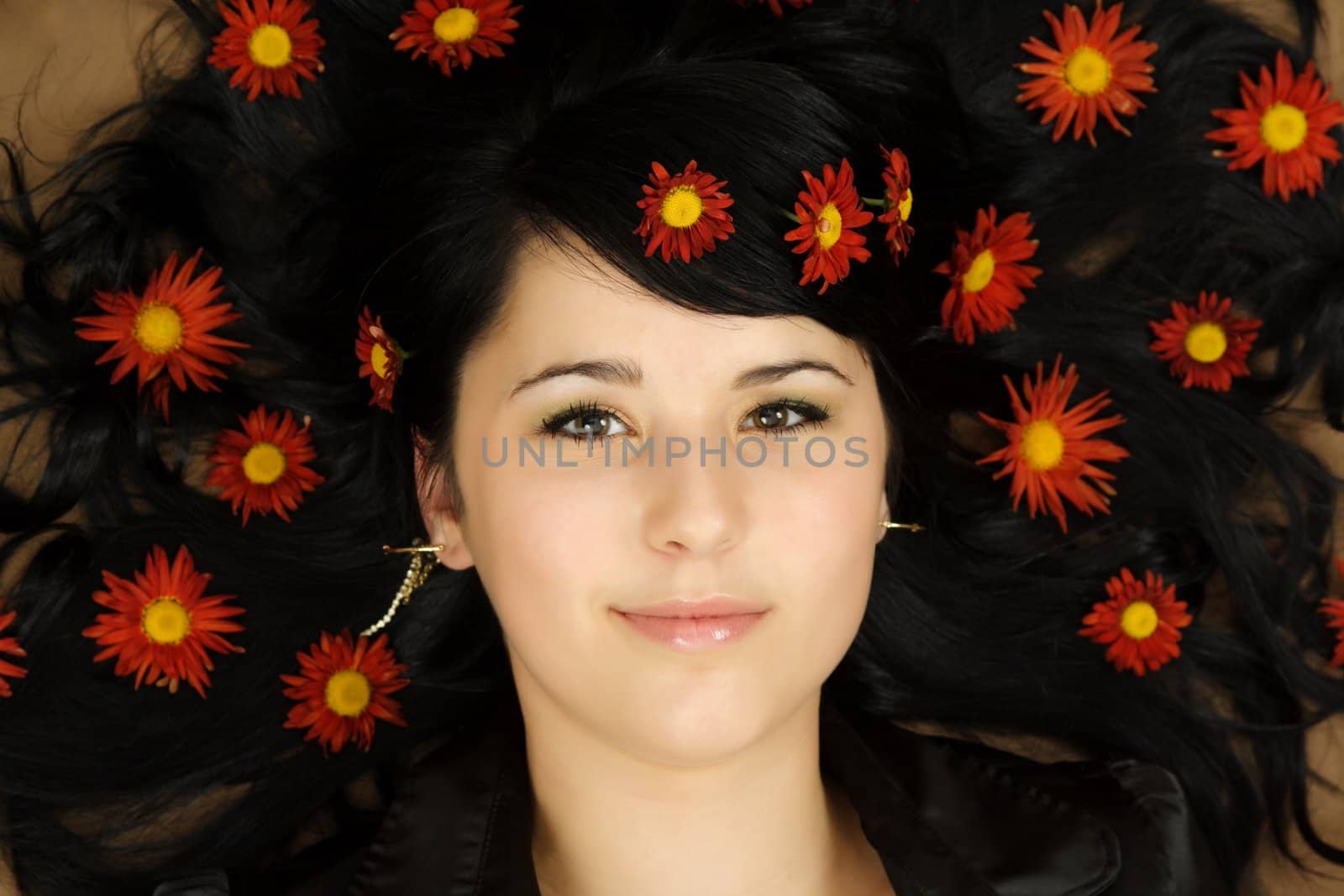 closeup portrait of nice girl with flowers on hair