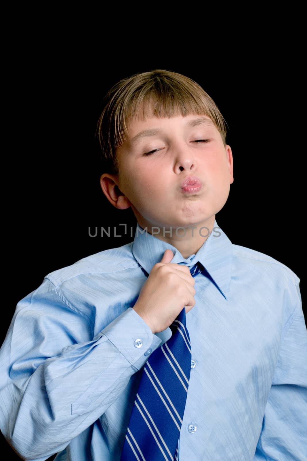 Schoolboy in a uniform adjusting tie