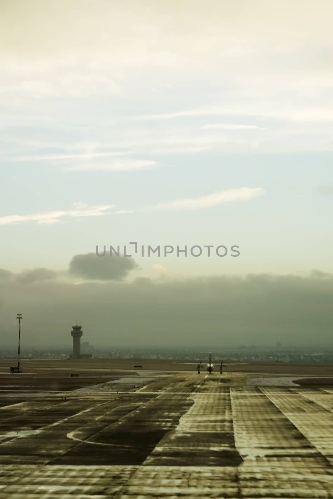 An airplane taxiing on the tarmac of an airport.