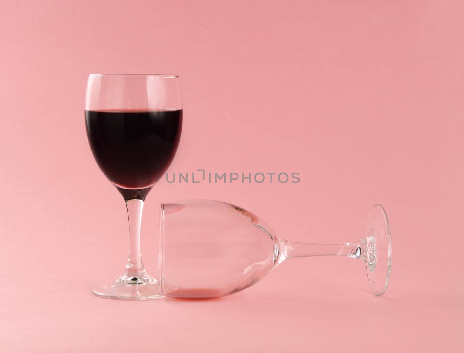 two red wine glasses, filled and empty