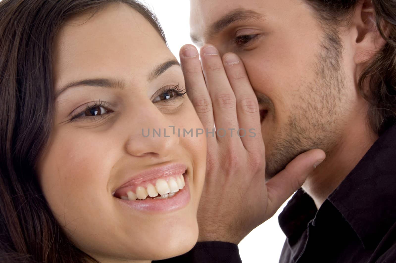 young man whispering to woman with white background