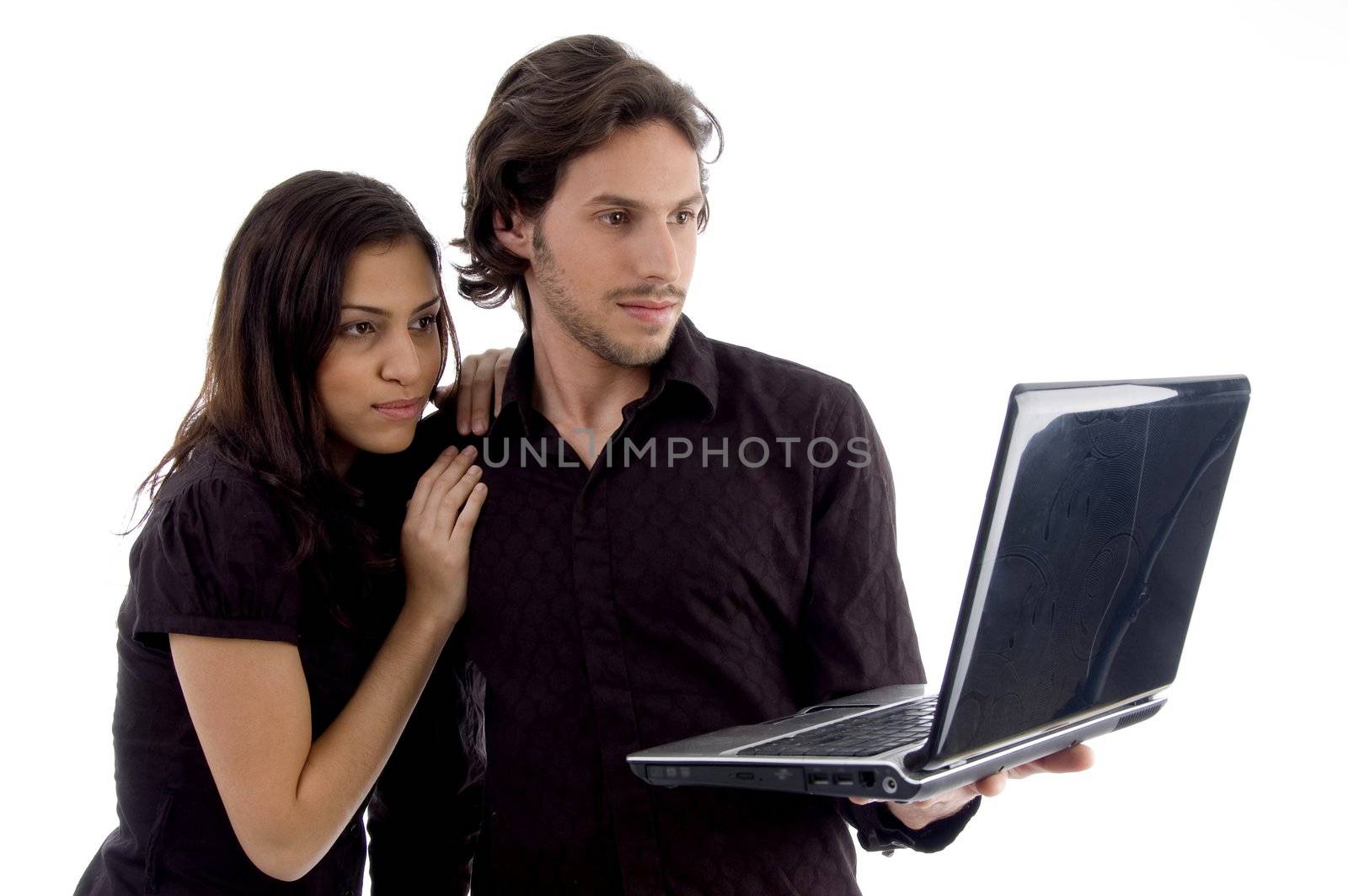 young couple looking into laptop by imagerymajestic