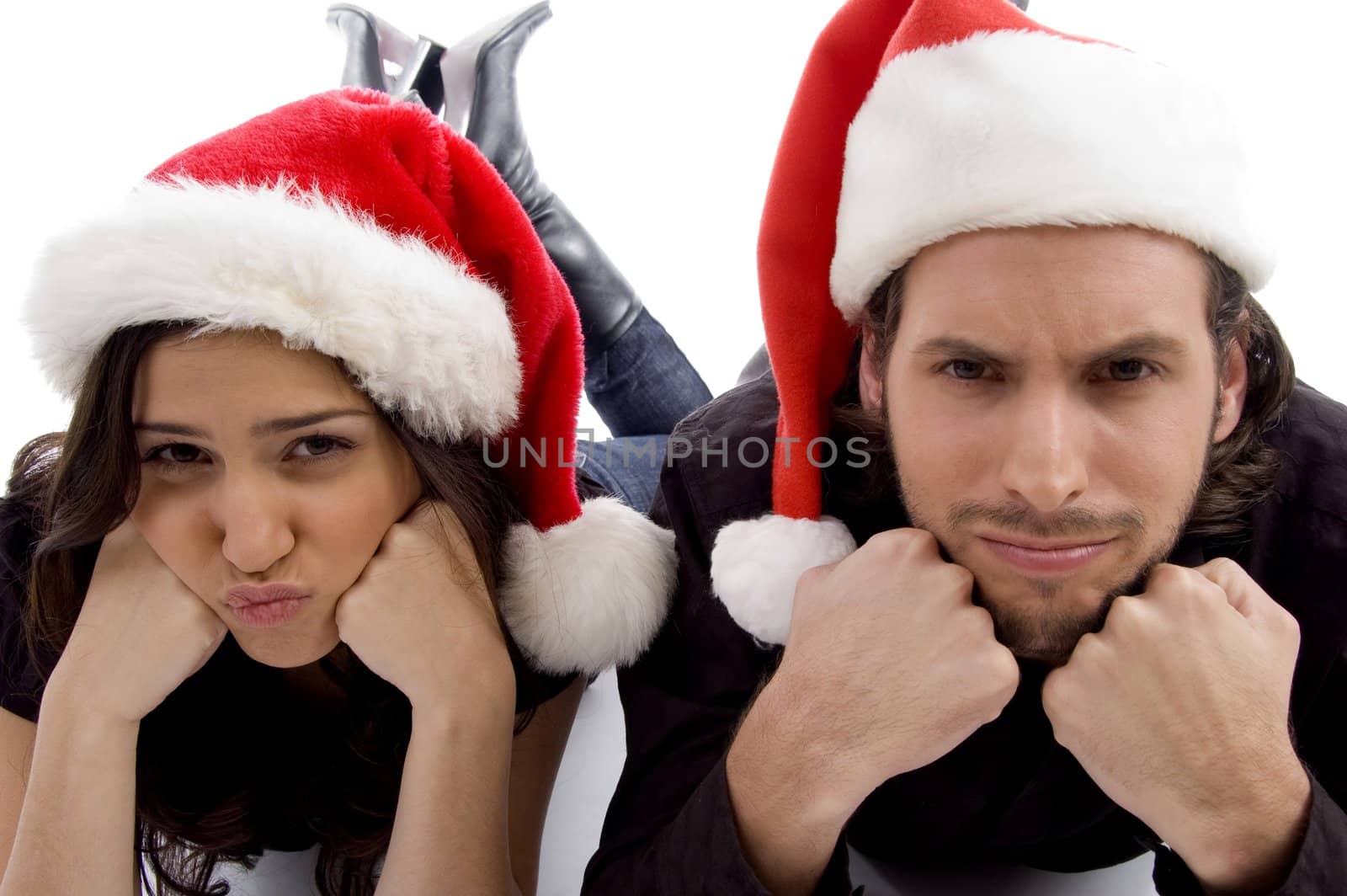 close up view of young couple wearing christmas hat and looking  by imagerymajestic