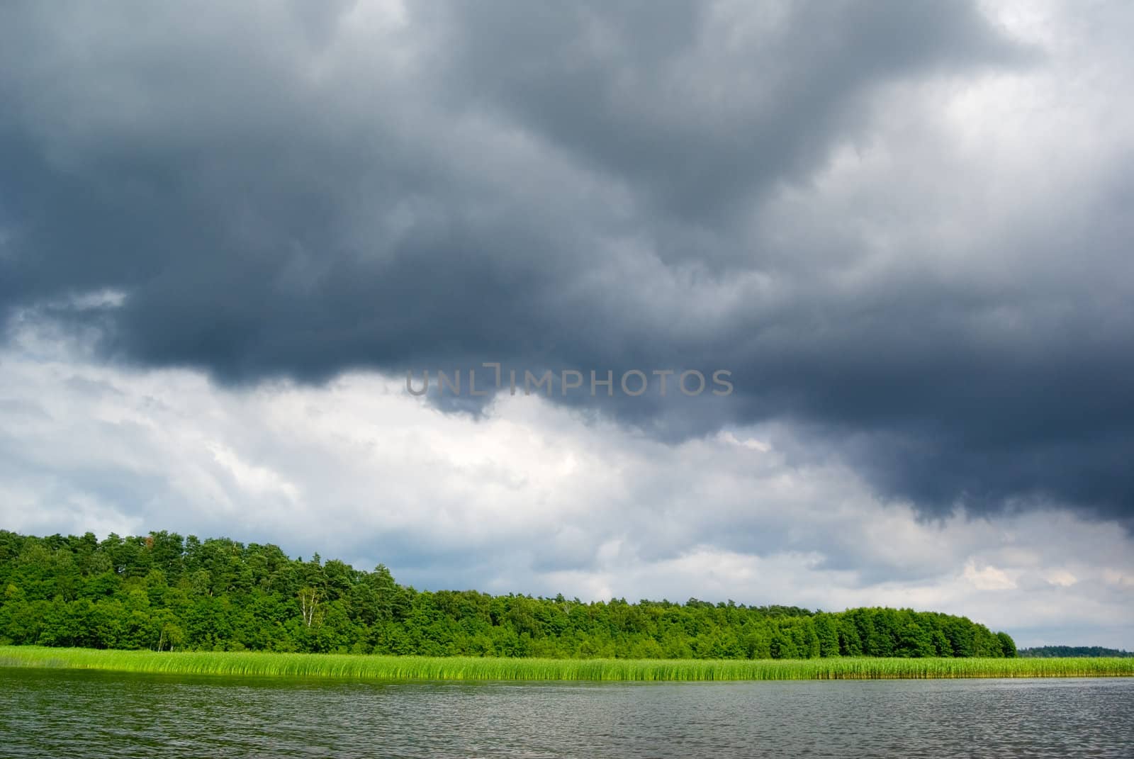 Stormy clouds over the lake. Mazury, Poland.