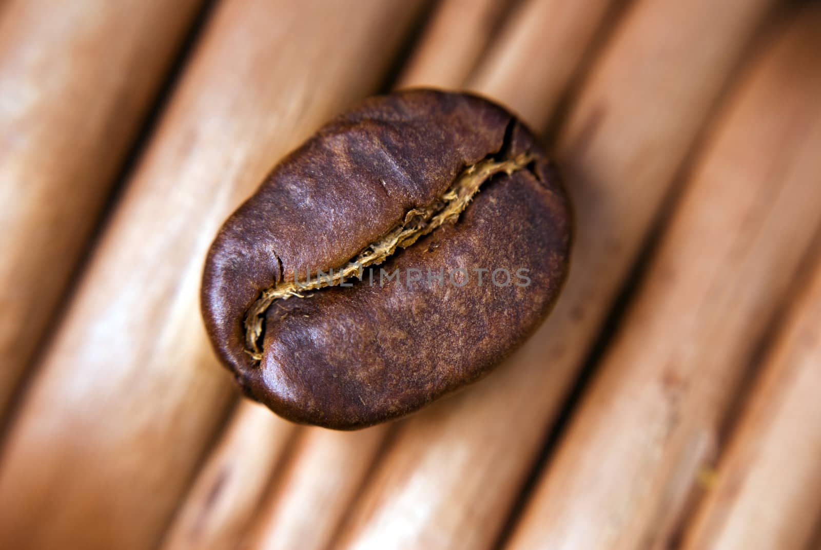 Coffee seed close-up on the wicker background.