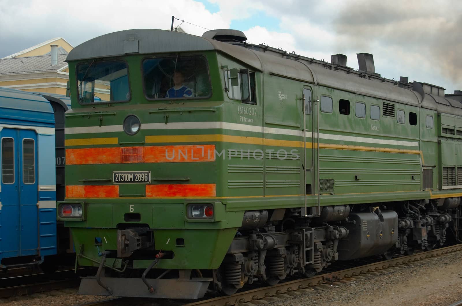 The cargo disel locomotive drives a heavy train