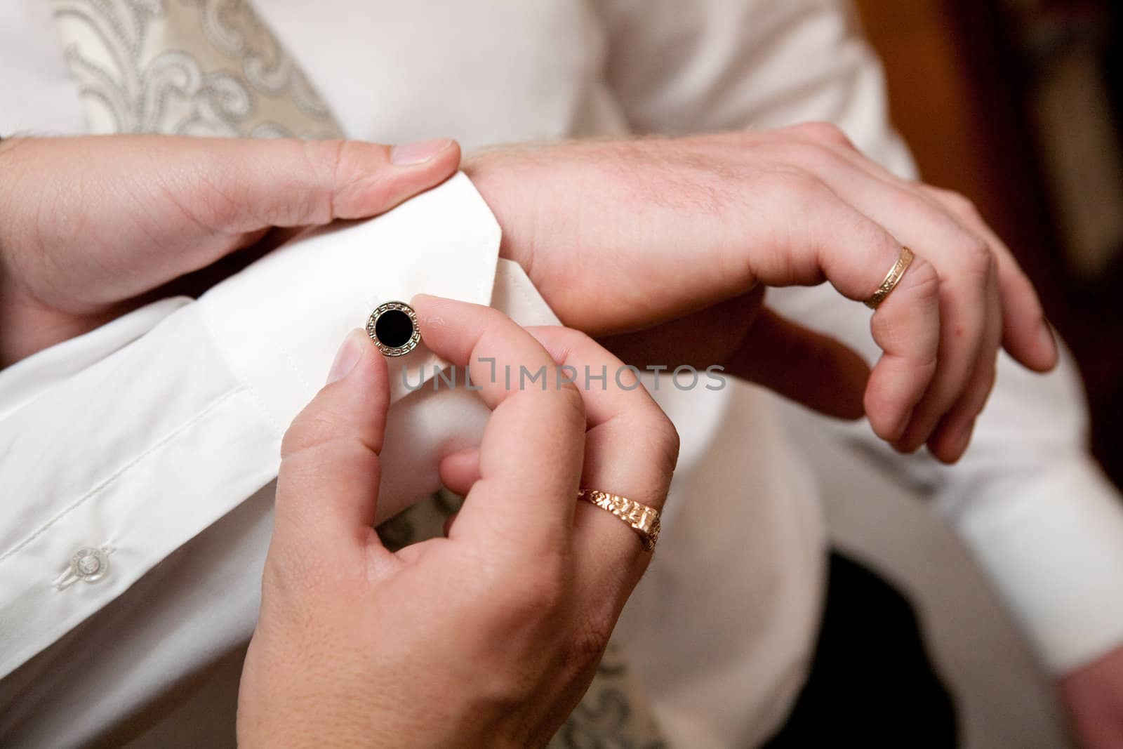 putting on a cufflink