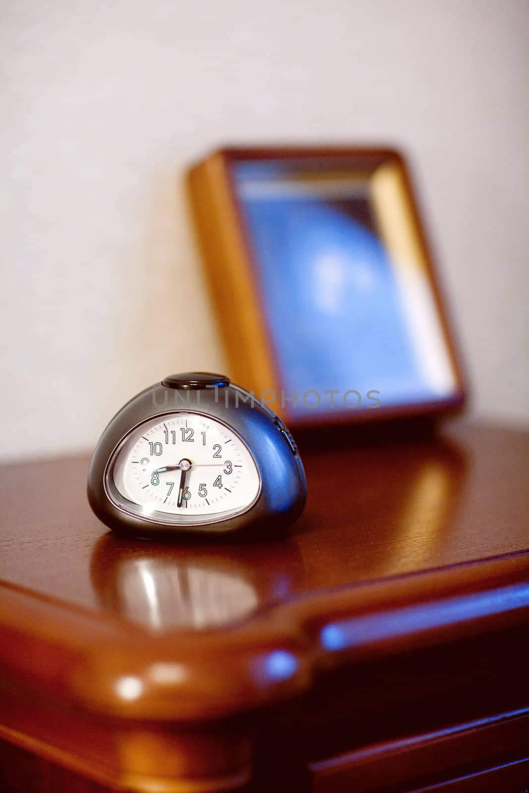 the alarm clock on the table