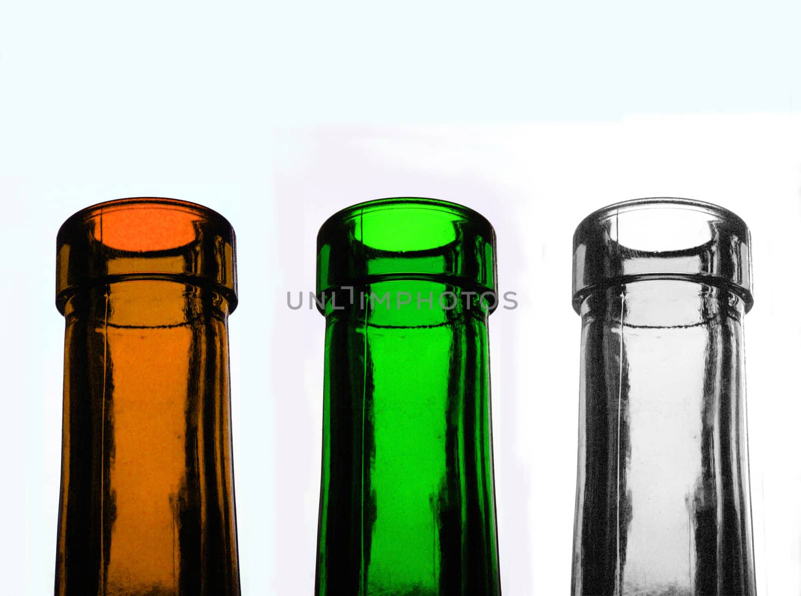 three recycable glass bottles in different colours, transparent, green, brown