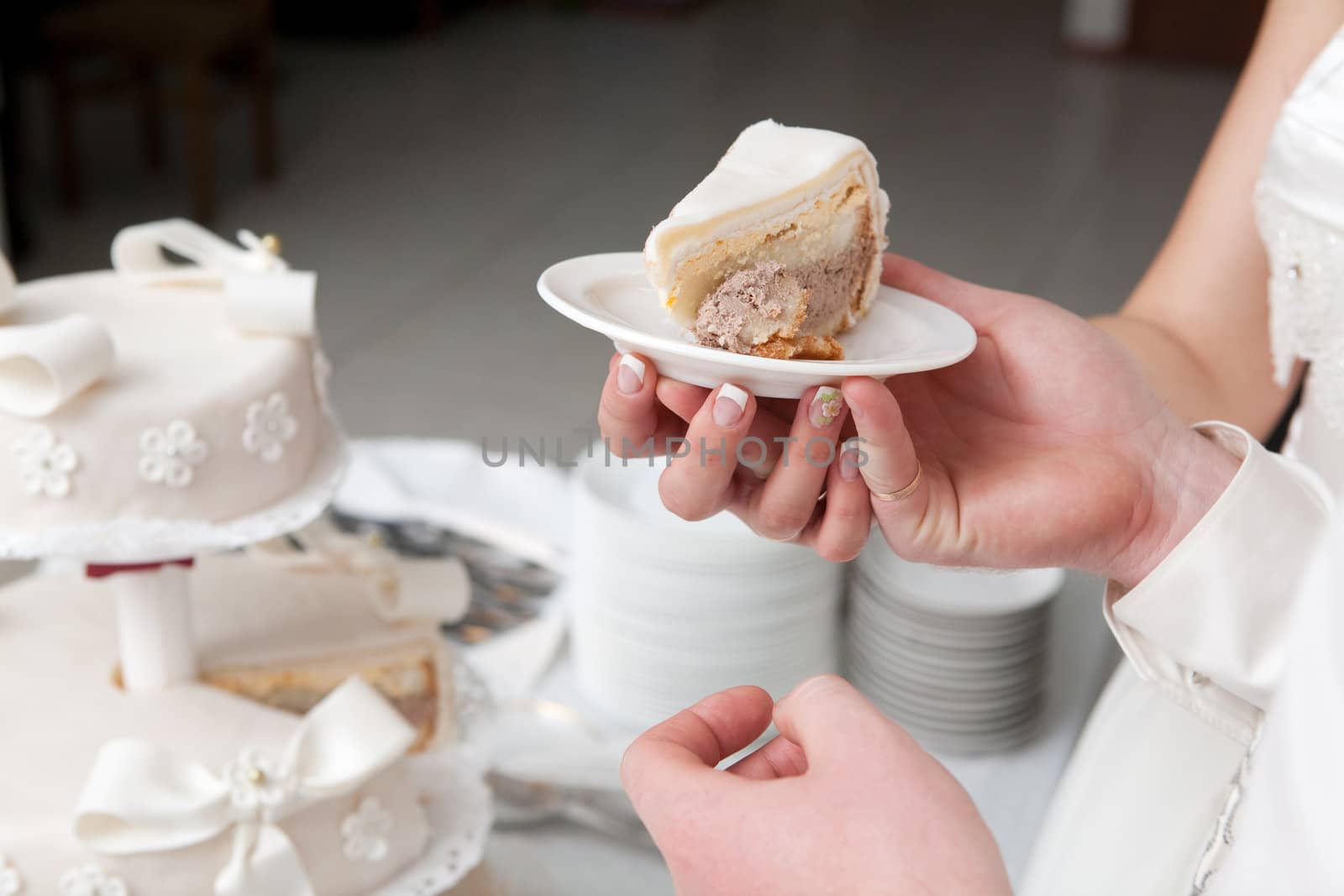 a slice of a wedding cake in hand
