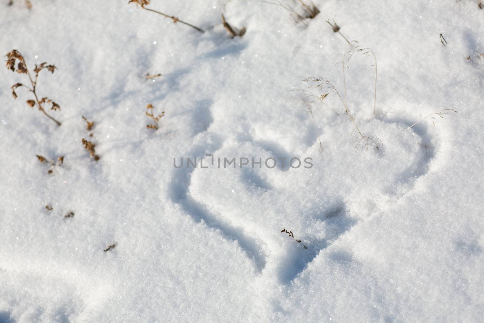 drawing of a heart on the snow